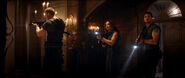 A promotional shot of Albert Wesker (Tom Hopper), Richard Aiken (Chad Rook), Jill Valentine (Hannah John-Kamen), and Chris Redfield (Robbie Amell) entering the foyer of the Spencer Mansion.