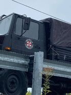 The left-hand side of the truck reveals the Umbrella logo, looking very similar to the UBCS logo from the RE3 remake.