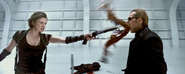 Alice aims at Wesker with a shotgun.