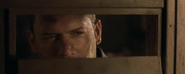 Chris, peering out of his cell