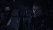 Chris Redfield inside a Toyota Hilux.