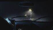 Leon driving in the rain towards Raccoon City