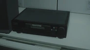 RE2make Biotesting Lab (9).jpg (103 KB) The lab digital video cassette being inserted inside the video player.