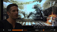 A screenshot of a Stalker behind Kevin Grow during a Gameinformer interview.