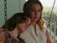 Emily pulling Charlotte close on swing.