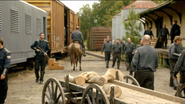 The Militia were seen walking near the steam locomotive.