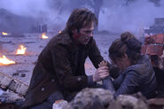 Miles gets Nora out from under the rubble.