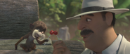 Big Boss holding a lollipop with the Emperor Tamarin, holding one each