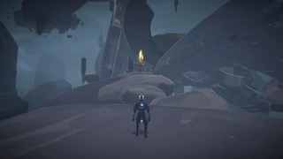 5. Behind the floating broken arch section before reaching the top of the path.