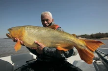 Jeremy holding a large Golden Dorado caught in Argentina.