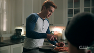 Season 1 Episode 10 The Lost Weekend Archie cutting pizza