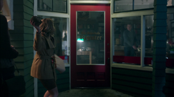 Alice throwing a rock through the window of The Register