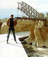 Crew member standing next to Sydney Harbour Bridge miniature