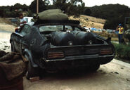 V8 Interceptor in scrap yard, back