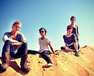 A production shot of Kravitz (center) on location in Namibia with Rosie Huntington-Whiteley, Riley Keough, and Courtney Eaton