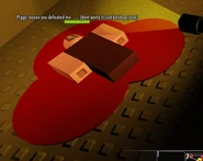Classic Piggy lying on the ground with "ketchup juice" underneath.