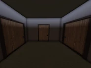 Another small hall, featuring a trio of doors