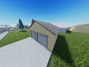 A garage building near the empty houses.