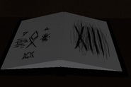 The book nearby the tree with a few symbols.