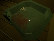 The couch bloodstained couch and cigarette pack as seen in the second room