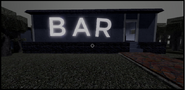 The bar that is on the left side of the well.
