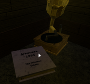 A book found in a corner of the Archives that serves as a teleport to Mr. Hollywood’s former second home in Arkansas.