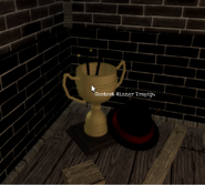 A trophy in the corner of the map that goes to the winner of a contest WaningLucidity hosted. The hat is a reference to the popular myth hunter, THEpeoplewhoSEES, as he was the winner.