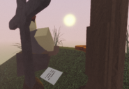 Cegnite sitting next to a headstone with a note nearby that says "I made this grave for my parents."