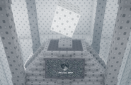 The machine with the rotating cube above it, clicking on the screen in front of it will activate the portal back inside the grey structure. The text on this screen will change when clicked.