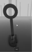 9. An odd mask located at the bottom of the small tree/radio receptor looking objects.