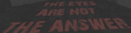The text seen scrawled on top of one of the stone pillars.