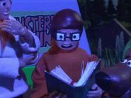 Velma reading a book about Jason