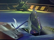 Mortis is nudged into the Pit by Gravedigger