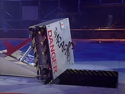 The Big Cheese hangs Shrapnel precariously over the precipice