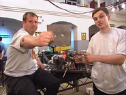 Pain's team with their machine and the aluminium plate punctured in testing