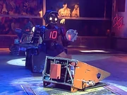 Mechaniac, overturned and damaged, is counted out