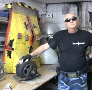 Mike Onslow with the shell of Plunderbird 4 (minus the claw) and one of Plunderbird 5's wheels in 2019