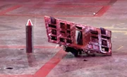 The battered Aftershock is flipped over by an Arena Spike