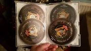 The opened DVD case, containing all five discs