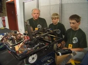 The team in the pits with Loco, without its shell, in a clip only shown in Robot Wars Revealed