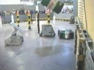 Zeus flipping an oil barrel during a live demonstration