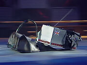 Big Brother drives Mace 2 towards the side wall