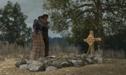 Jack and Abigail standing next to John's grave.