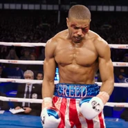 Adonis Creed wearing the classic USA trunks in homage to his father Apollo Creed and Rocky Balboa during his fight against Ricky Conlan, seen in Creed.