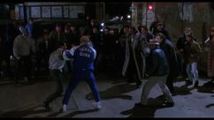 Rocky and Tommy wrestle outside of the bar