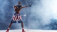 Adonis Creed wearing the classic second version of American Costume during his first fight against Viktor Drago, seen in Creed II.