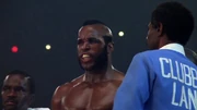 Lang slapping Creed's hand away.