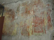 The major fresco fragment, to the right of the entrance (more behind info board on left).