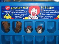 Shoe bin used form 1995 to 2008 featuring the rules of "RONALD'S WAY TO PLAY!!!": "1. Be a friend! Take turns and share! Big kids, help the little kid have fun! 2. Leave toys, food, and other stuff back at the tables. 3. Play safe! Enter the play area slowly, so you don't bump into anybody. 4. Leave your shoes here. 5. Kids 3 to 12 can play. Parents, too!!"