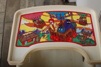 One of two optional trays to put on the highchair. This one featuring a theme of McDonaldland.